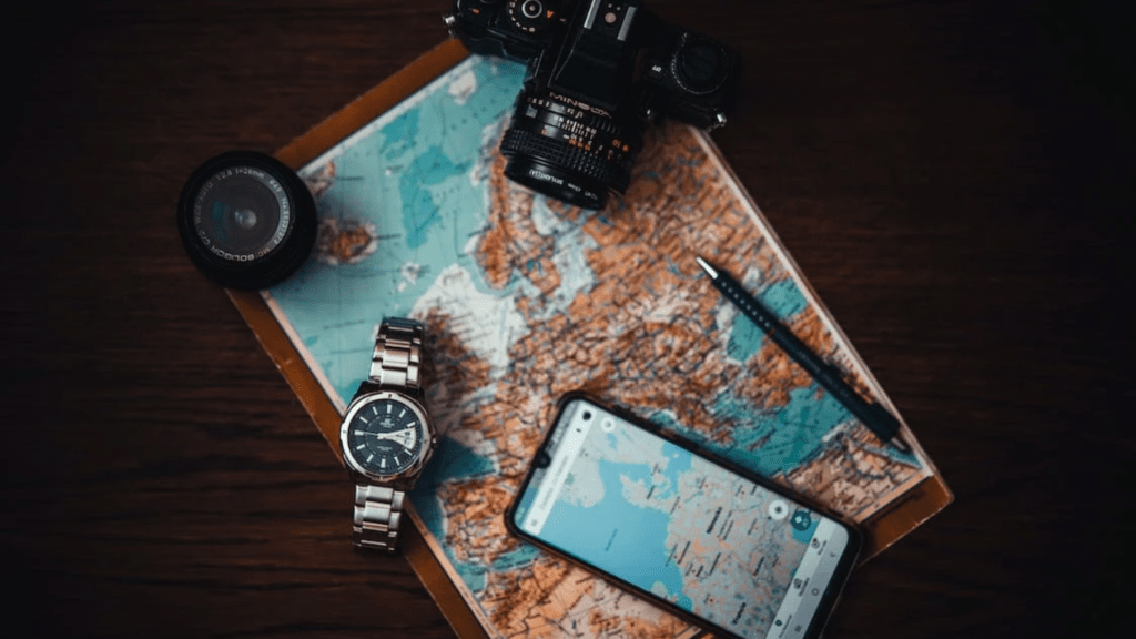 Image shows things needed for travels like map watch camera etc